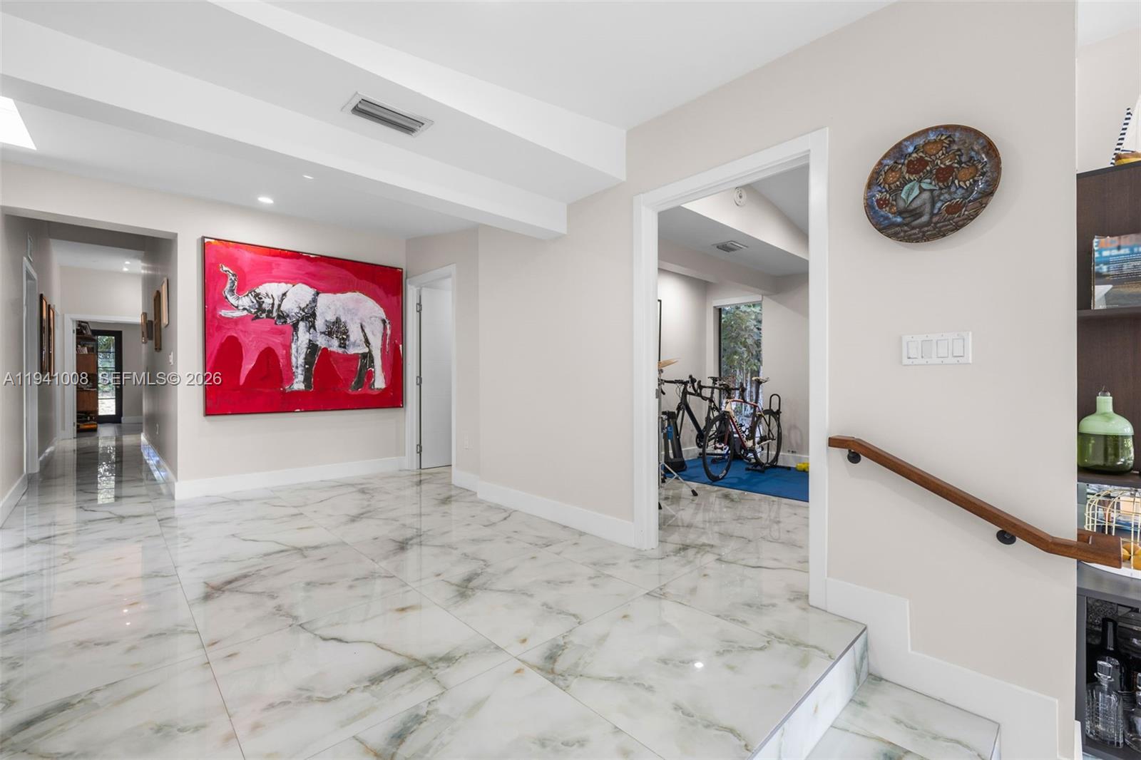 12033 Acme Road Wellington, FL 33414 - Photo 13 of 30 a view of a hallway with paintings on the wall