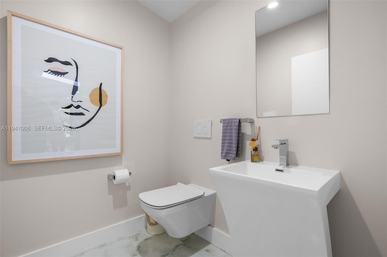 12033 Acme Road Wellington, FL 33414 - Photo 14 of 30 a bathroom with a toilet sink and mirror