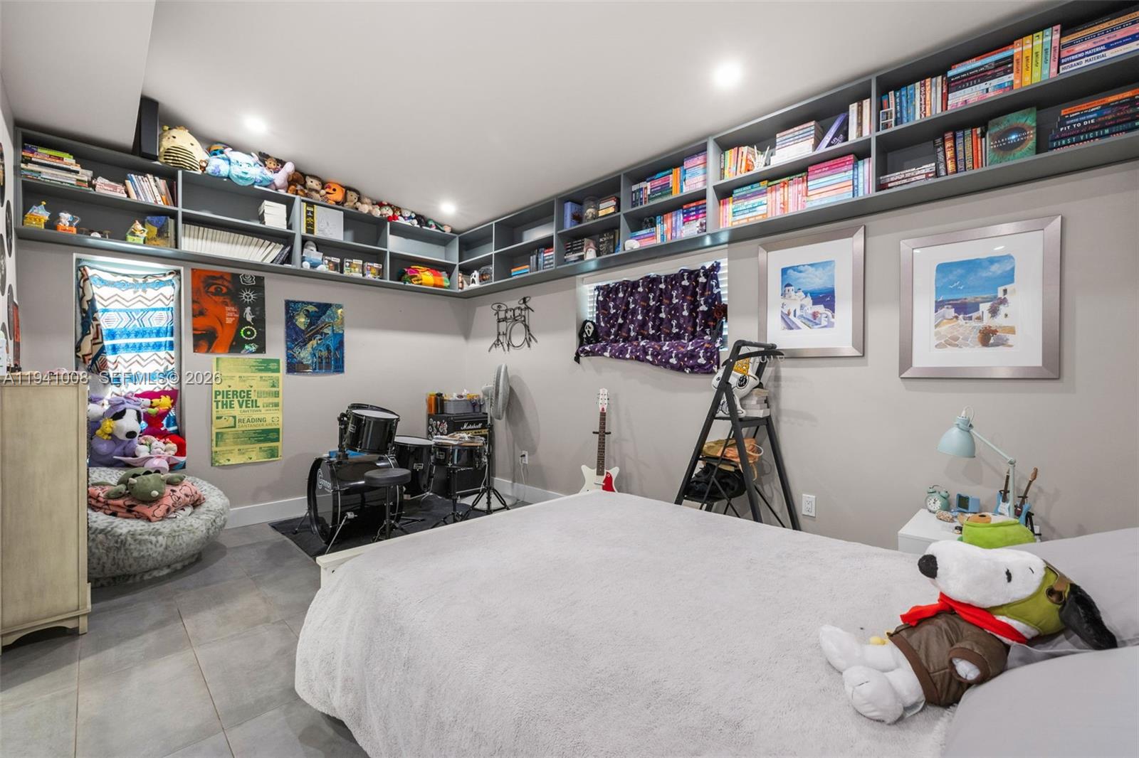 12033 Acme Road Wellington, FL 33414 - Photo 18 of 30 a bedroom with bed and a book shelf