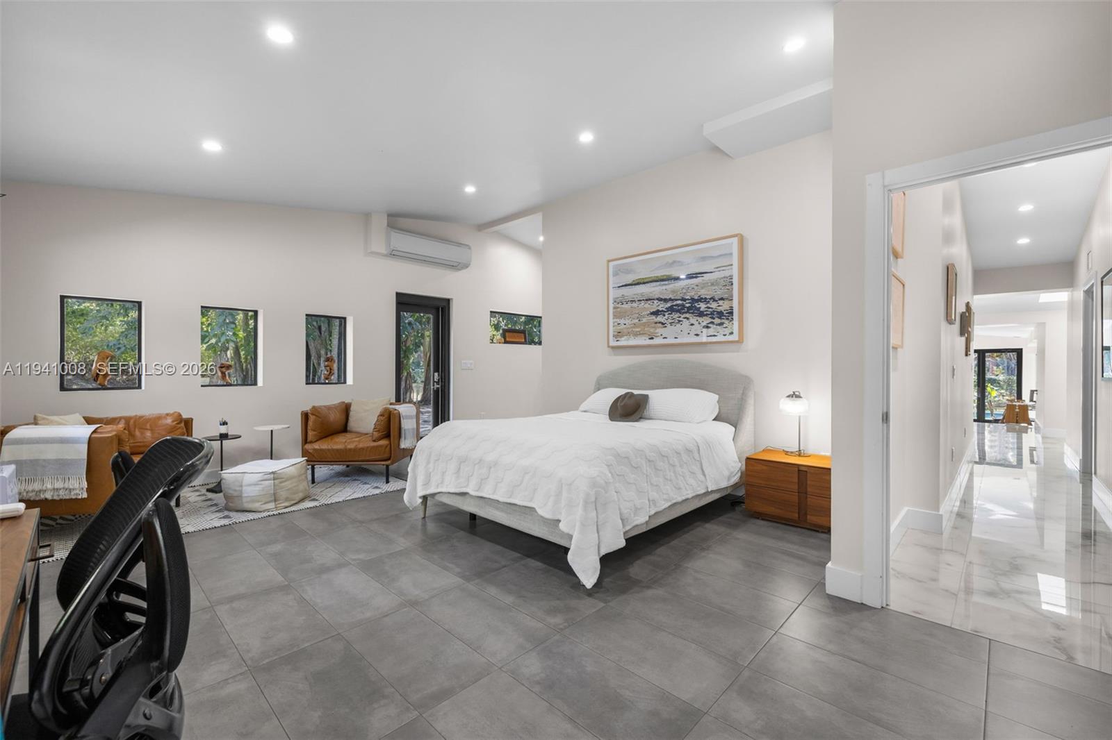 12033 Acme Road Wellington, FL 33414 - Photo 21 of 30 a spacious bedroom with a bed a couch and dresser