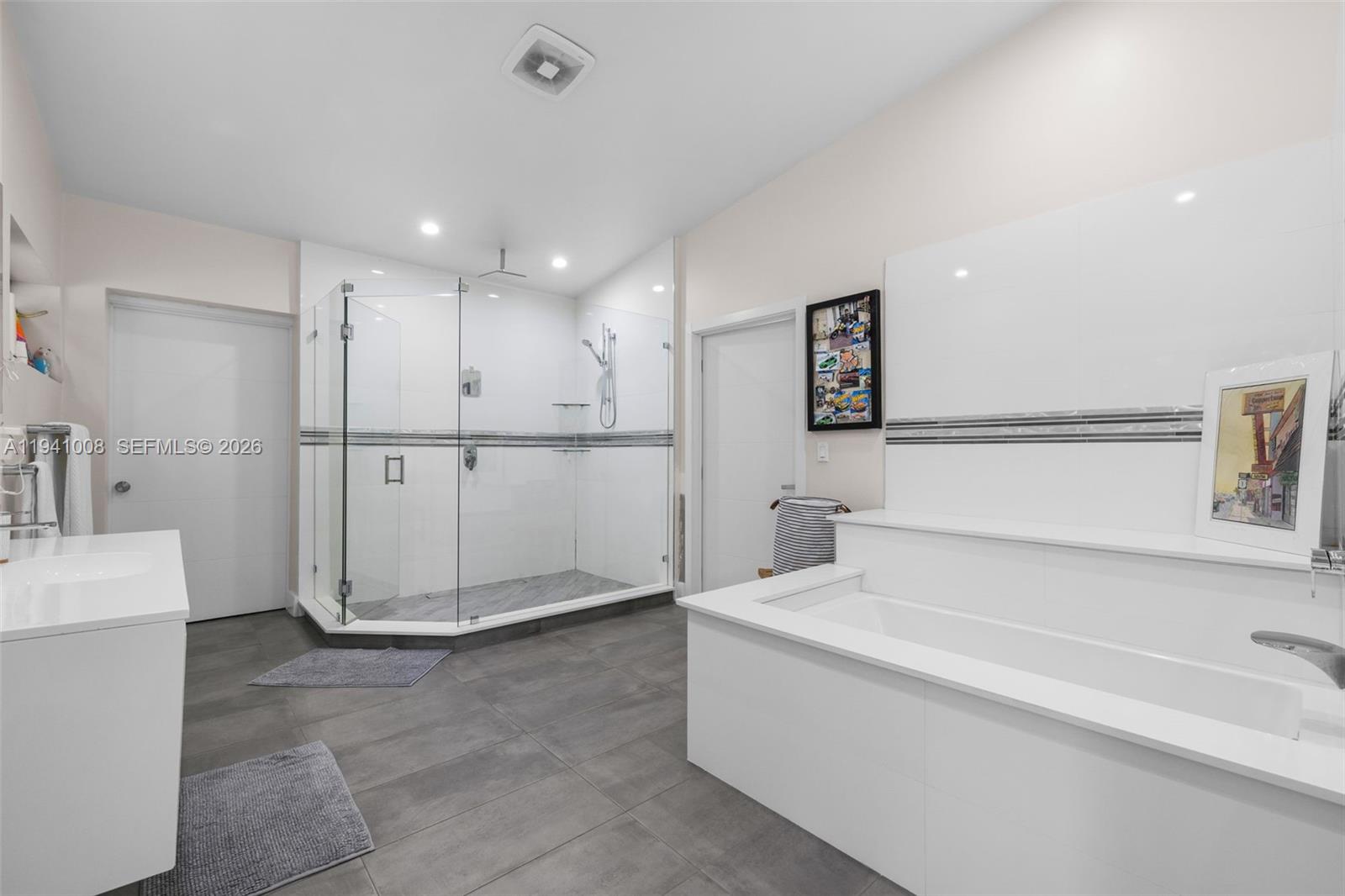 12033 Acme Road Wellington, FL 33414 - Photo 23 of 30 a spacious bathroom with a tub a sink and a shower