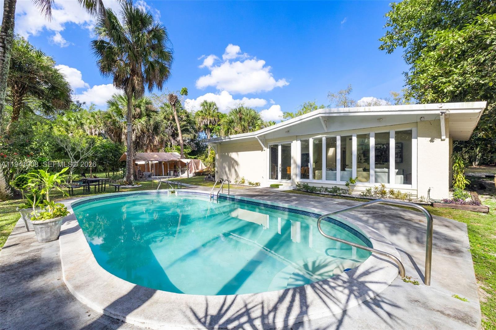 12033 Acme Road Wellington, FL 33414 - Photo 26 of 30 a view of a swimming pool with a patio