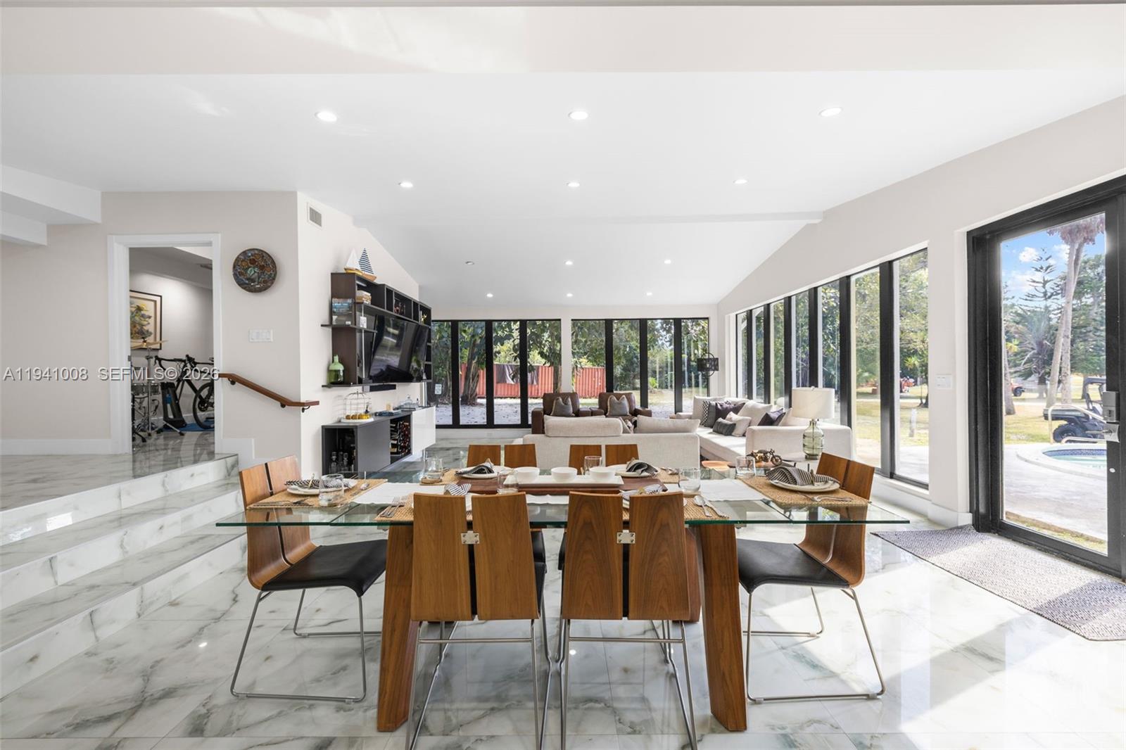 12033 Acme Road Wellington, FL 33414 - Photo 5 of 30 a dinning room with stainless steel appliances kitchen island granite countertop a stove and a sink