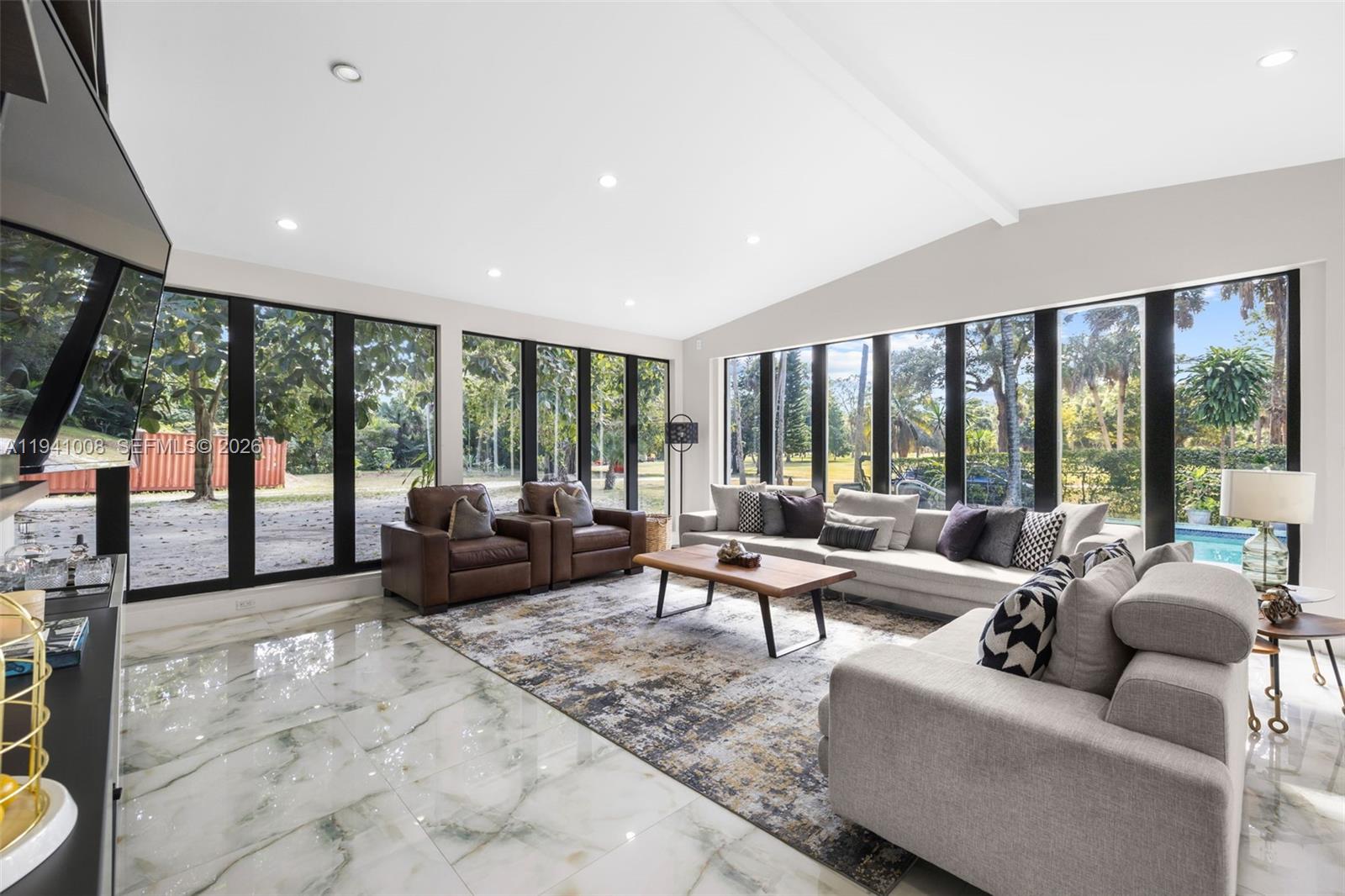 12033 Acme Road Wellington, FL 33414 - Photo 6 of 30 a living room with furniture and large windows