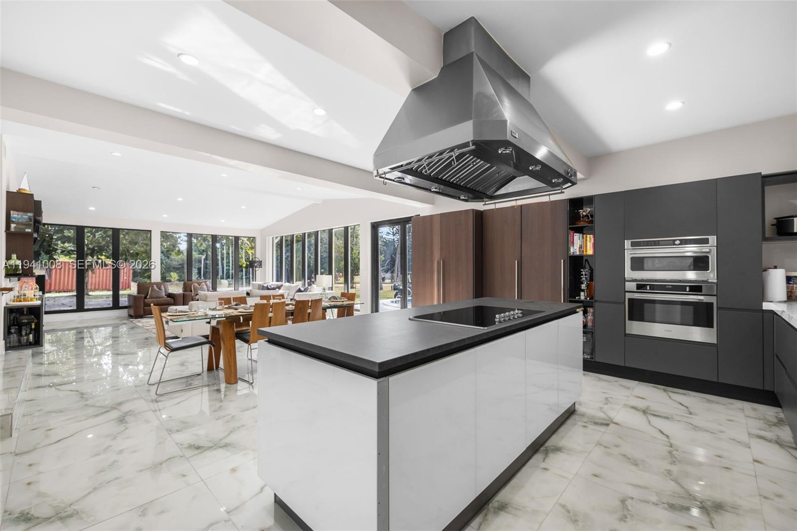 12033 Acme Road Wellington, FL 33414 - Photo 7 of 30 a kitchen with stainless steel appliances granite countertop a stove and a refrigerator