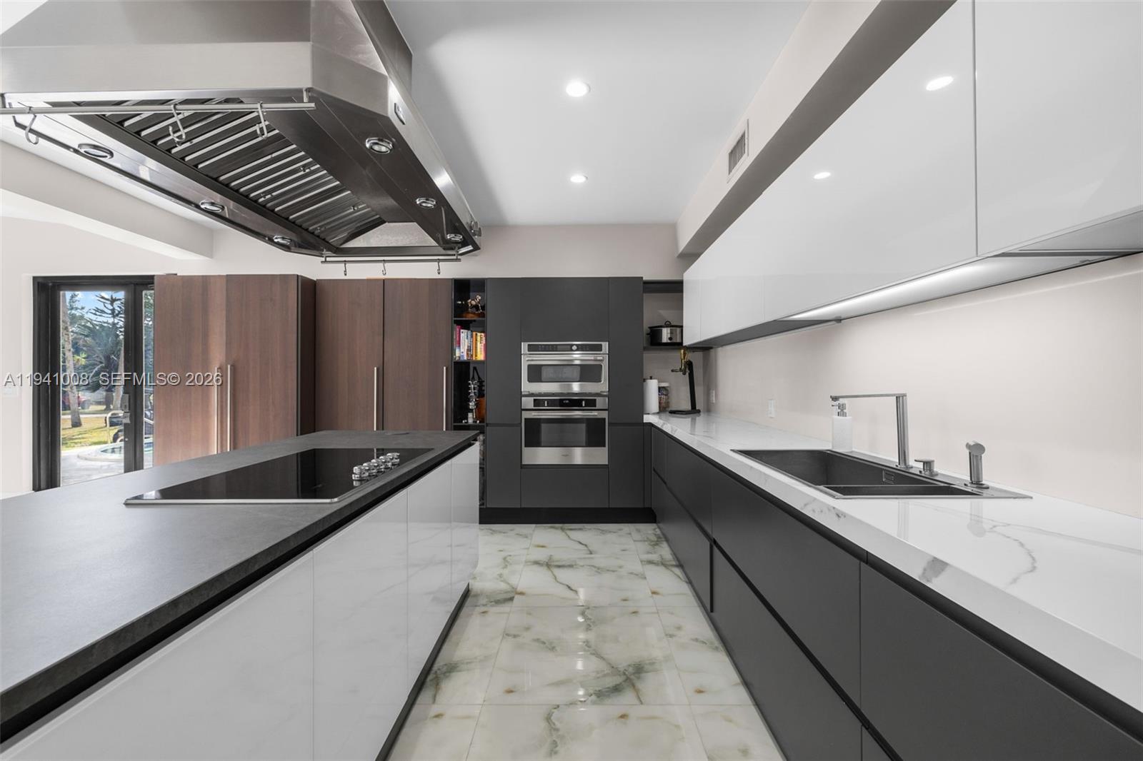 12033 Acme Road Wellington, FL 33414 - Photo 8 of 30 a large kitchen with stainless steel appliances a large counter top