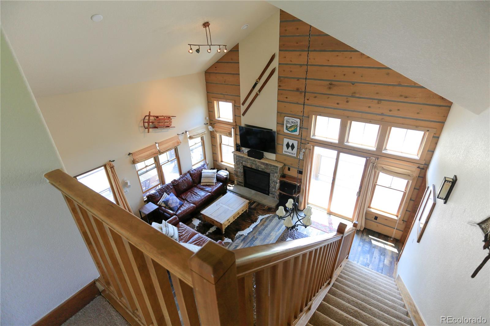 1324 Rendezvous Road Fraser, CO 80442 - Photo 14 of 36 a living room with furniture a fireplace and a large window
