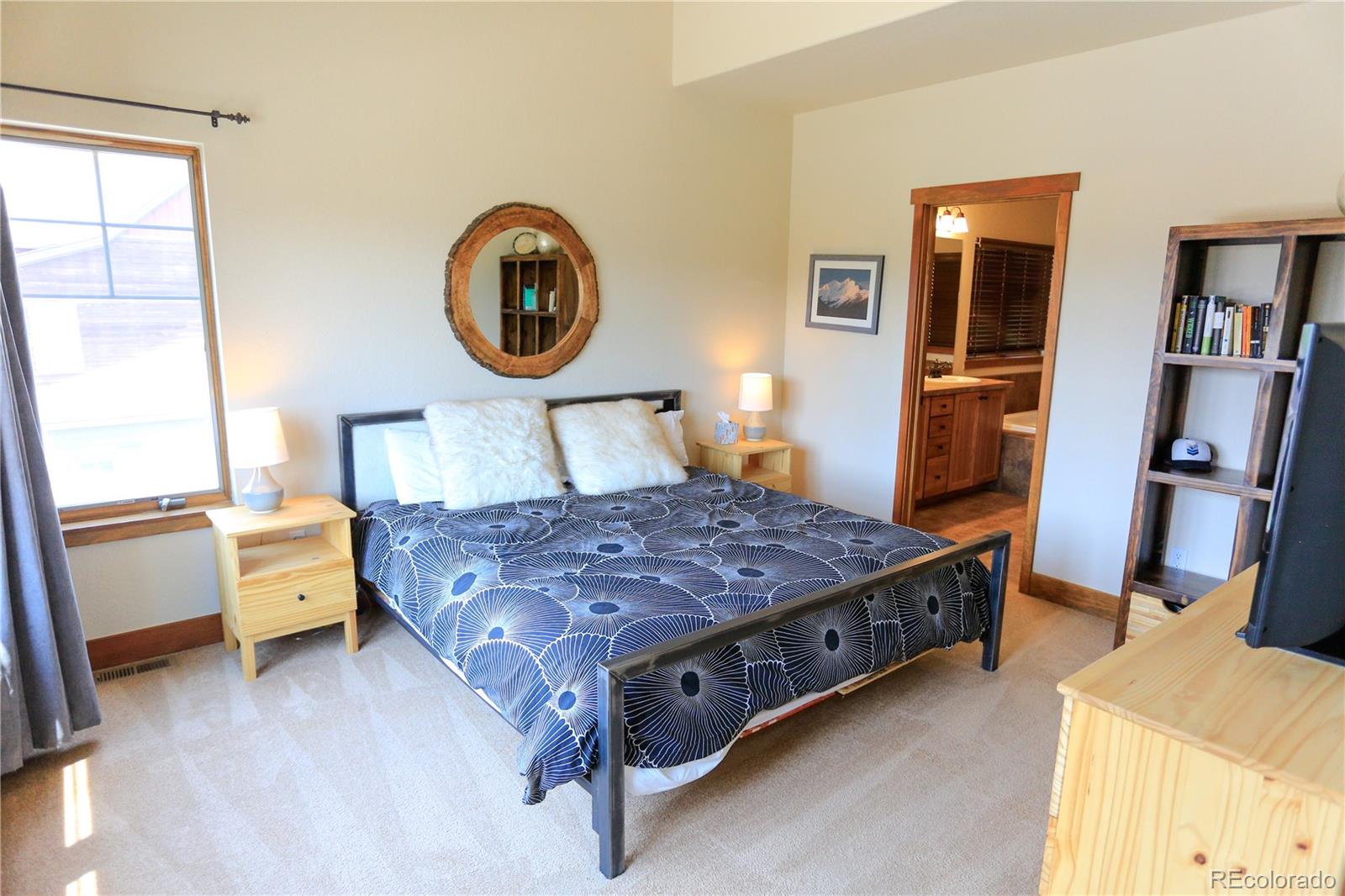 1324 Rendezvous Road Fraser, CO 80442 - Photo 17 of 36 a bed sitting in a bedroom next to a window