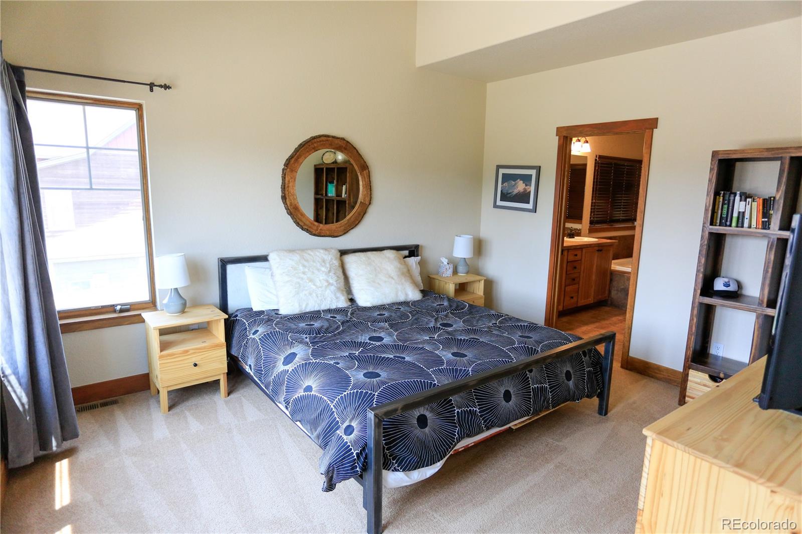 1324 Rendezvous Road Fraser, CO 80442 - Photo 19 of 36 a bedroom with a bed and wooden floor