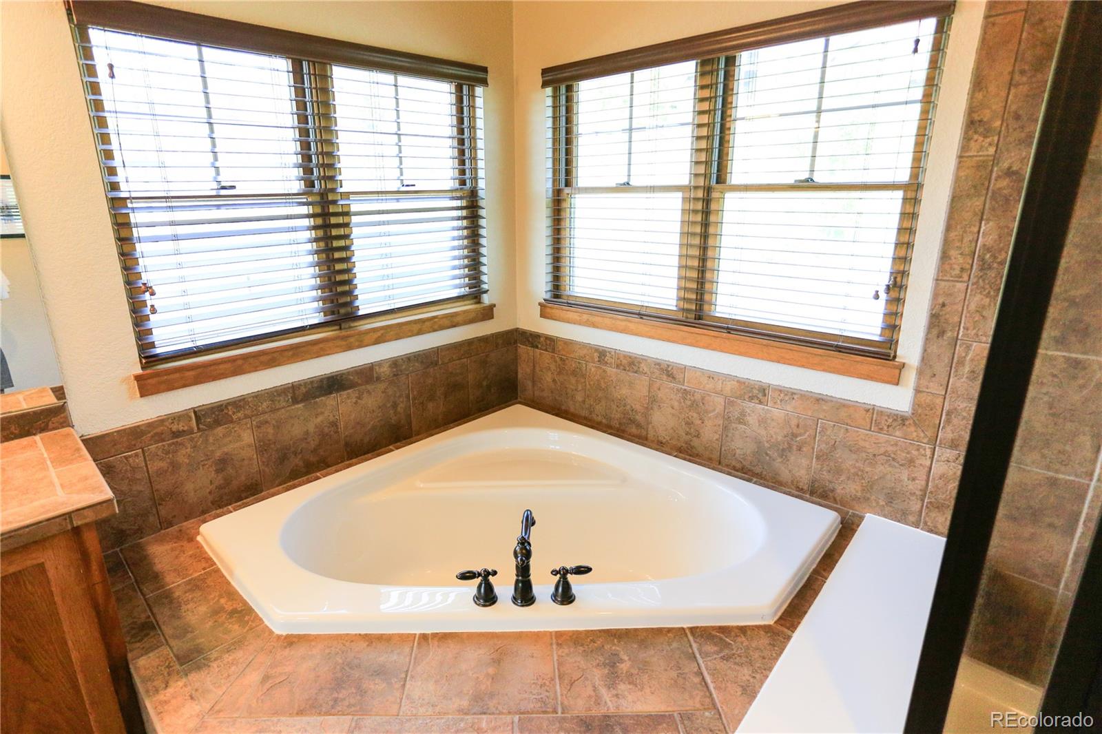 1324 Rendezvous Road Fraser, CO 80442 - Photo 20 of 36 a bath tub sitting in a bathroom next to a window