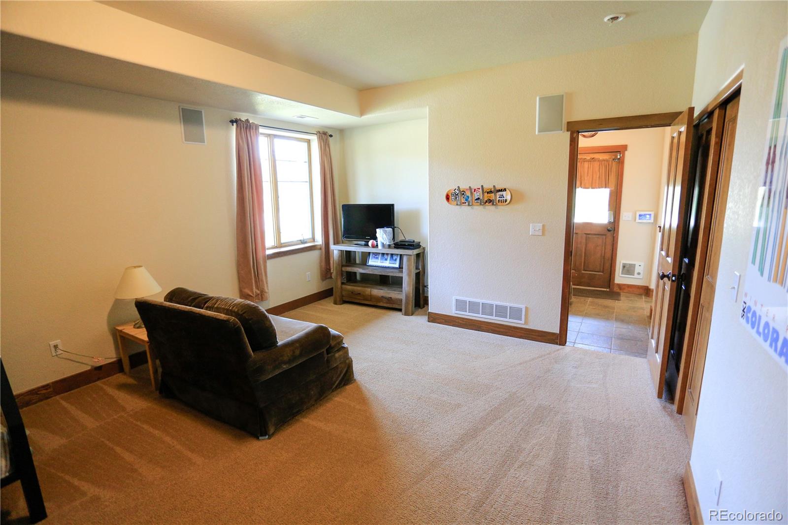 1324 Rendezvous Road Fraser, CO 80442 - Photo 24 of 36 a living room with furniture and a flat screen tv