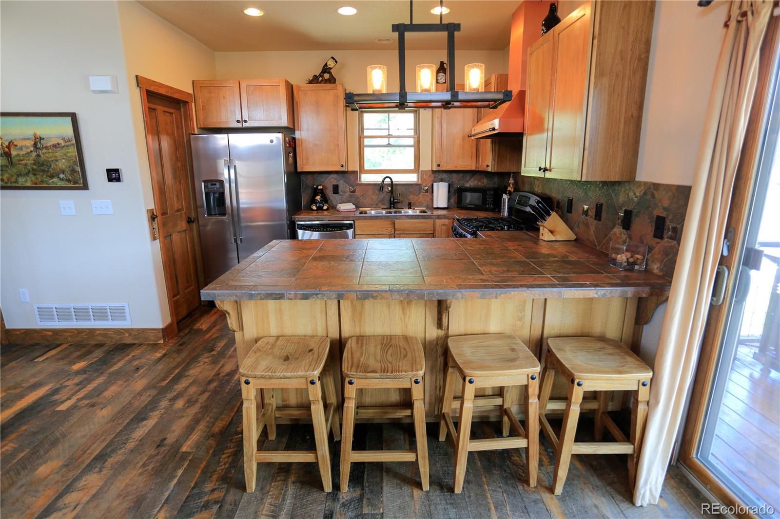 1324 Rendezvous Road Fraser, CO 80442 - Photo 10 of 36 a kitchen with furniture wooden floor and a refrigerator