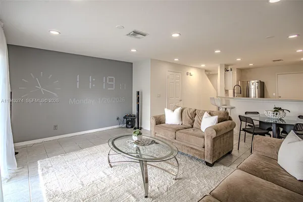 a living room with furniture kitchen view and a table
