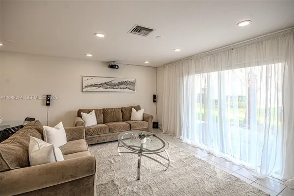 a living room with furniture and a large window