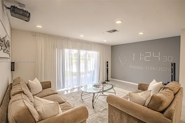 a living room with furniture and a large window