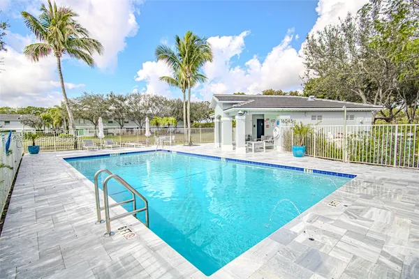 a view of a house with swimming pool with a porch