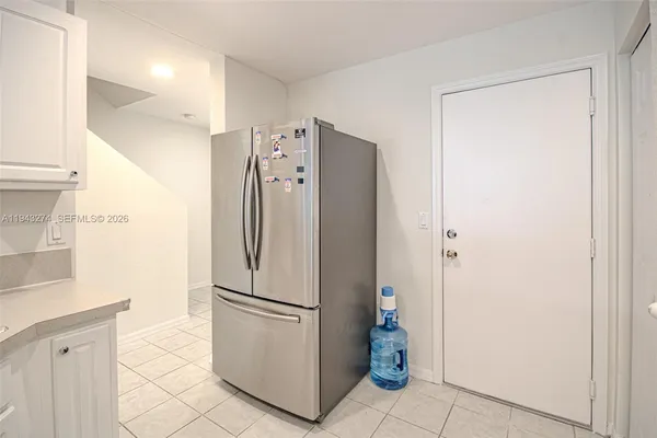 a kitchen with stainless steel appliances a refrigerator and a cabinets