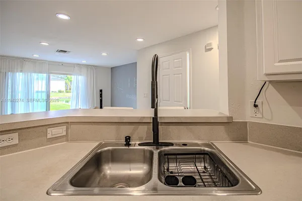a kitchen with a sink and cabinets