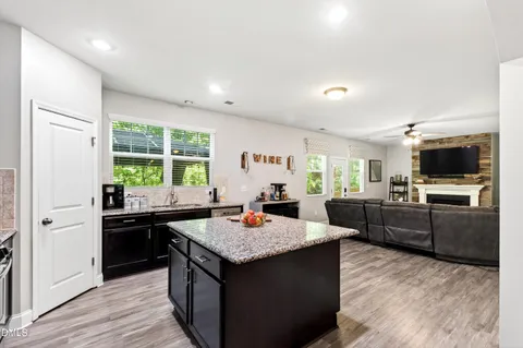 a kitchen with granite countertop a stove and refrigerator