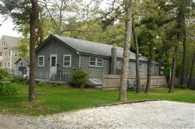 11 Child's Road Mashpee, MA 02649 - Photo 2 of 4 a view of a yard in front of a house with large windows