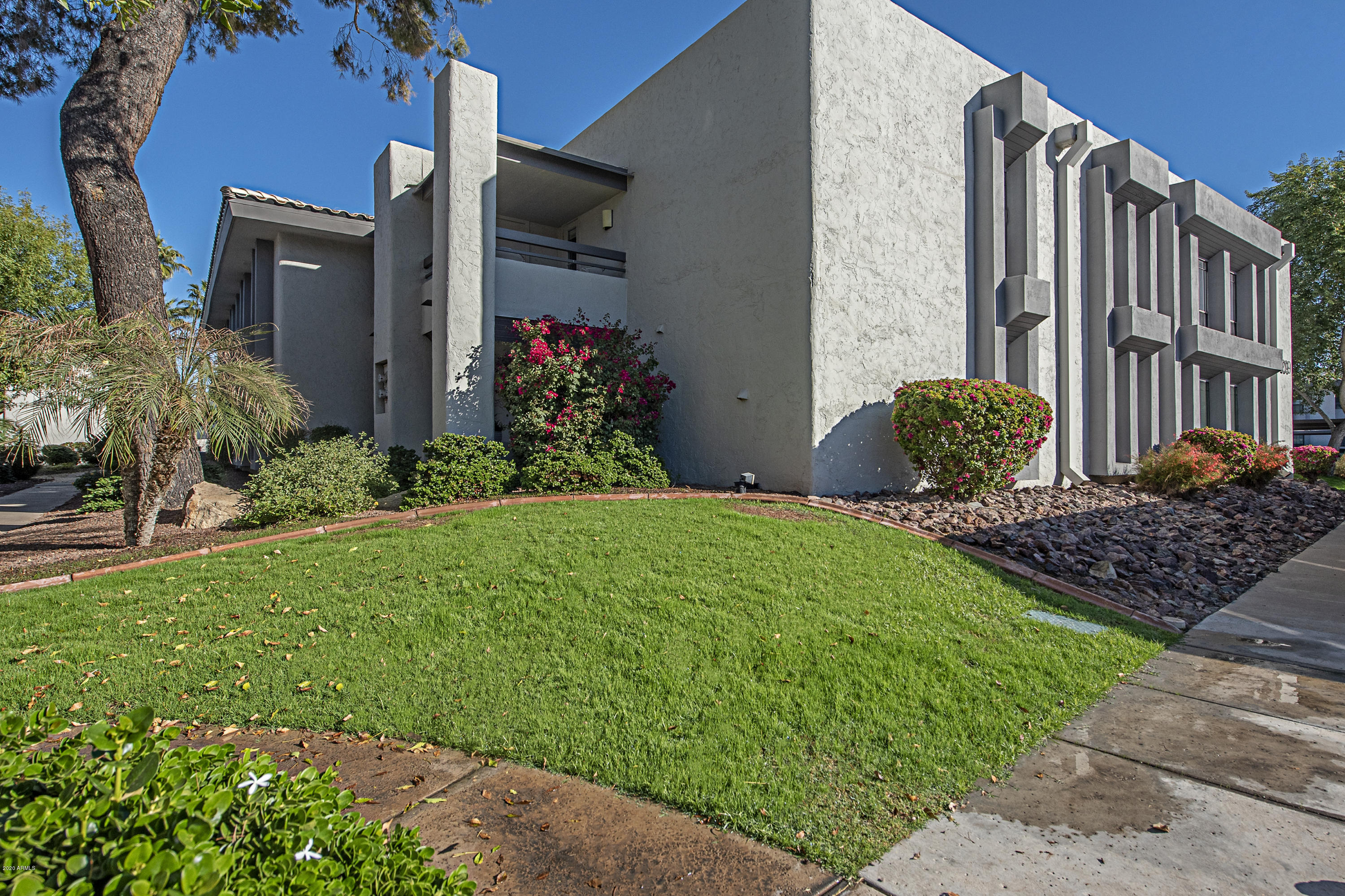 5209 North 24th Street, Unit 103 Phoenix, AZ 85016 - Photo 15 of 17 a front view of a house with a yard