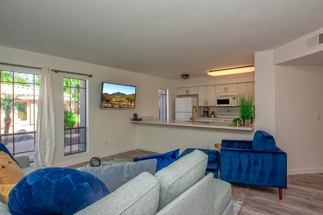 a living room with furniture window and a potted plant