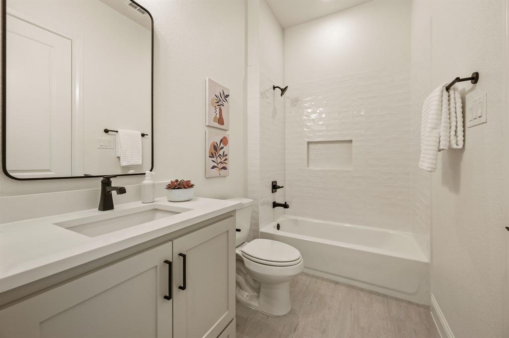 3006 Wheeler Branch Road Granbury, TX 76049 - Photo 24 of 29 Bathroom featuring a single vanity with light cabinetry, a rectangular undermount sink, and a light-toned countertop