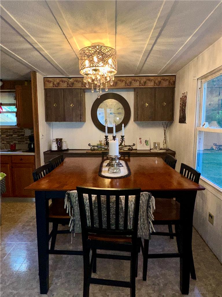 381 Red Oak Lane Bath, PA 18014 - Photo 12 of 27 A charming dining area features a unique chandelier illuminating a warm wood-top table.