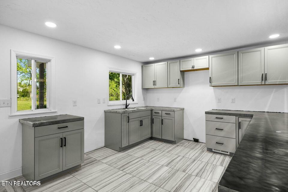 516 Delaware Avenue Oak Ridge, TN 37830 - Photo 12 of 43 a kitchen with a stove a sink and a microwave