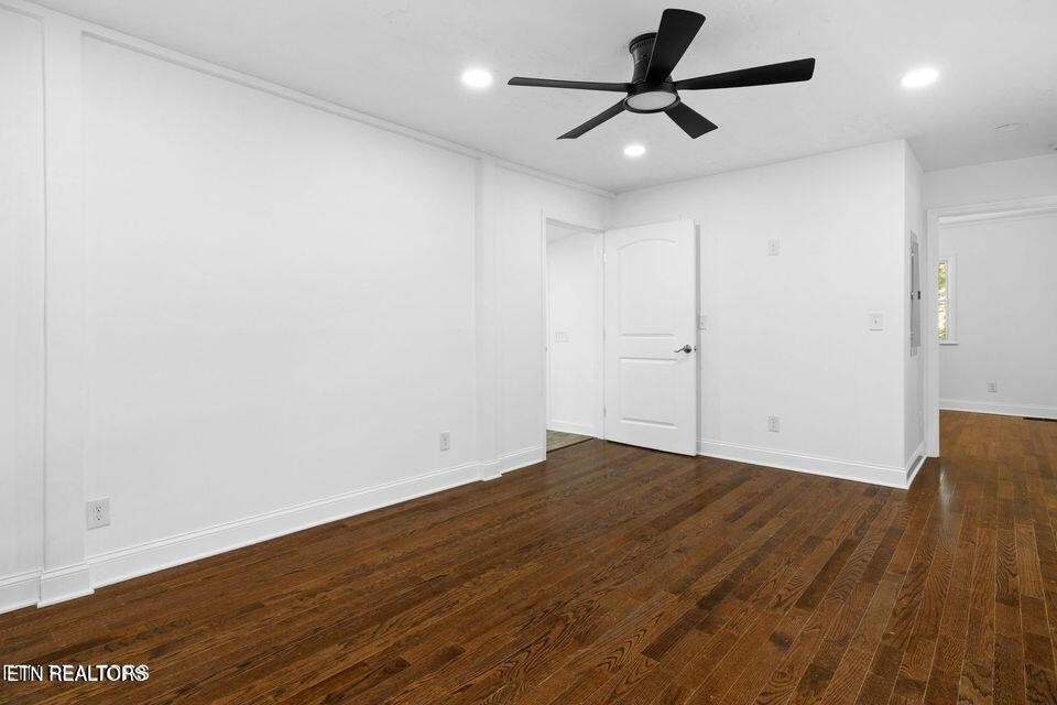 516 Delaware Avenue Oak Ridge, TN 37830 - Photo 24 of 43 an empty room with wooden floor and windows