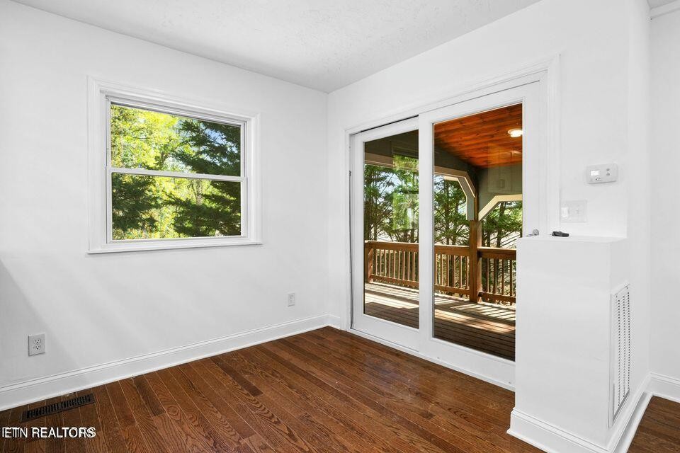 516 Delaware Avenue Oak Ridge, TN 37830 - Photo 25 of 43 an empty room with wooden floor and windows