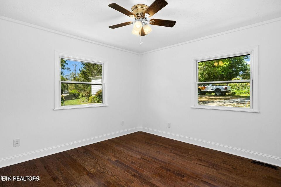 516 Delaware Avenue Oak Ridge, TN 37830 - Photo 32 of 43 a view of an empty room with window and wooden floor