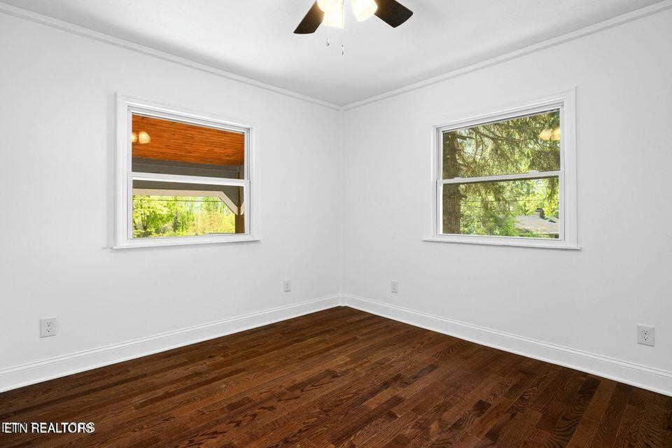 516 Delaware Avenue Oak Ridge, TN 37830 - Photo 34 of 43 a view of an empty room with wooden floor and a window