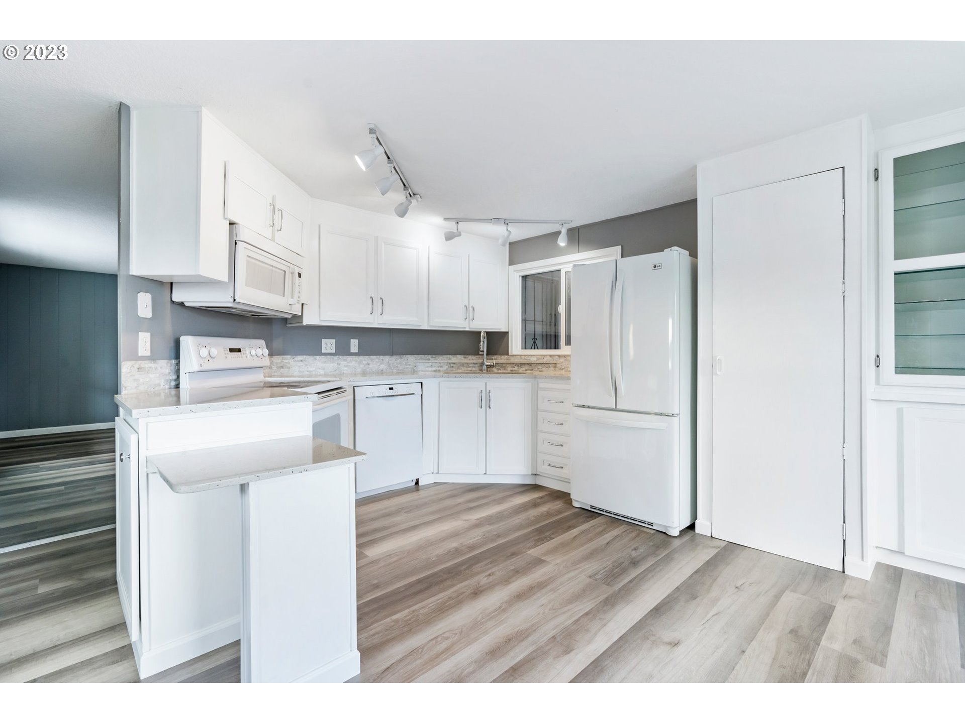 9183 Southwest Line Drive Cornelius, OR 97113 - Photo 6 of 38 a kitchen with stainless steel appliances granite countertop a refrigerator sink and white cabinets