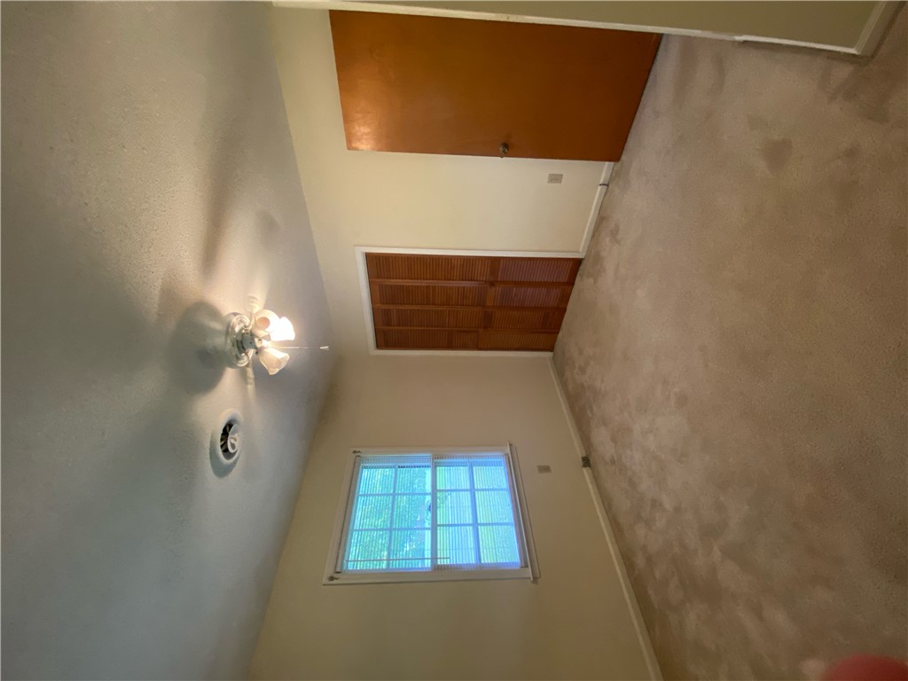 1424 East Calhoun Street Anderson, SC 29621 - Photo 7 of 10 Comfortable carpeted bedroom with a window offering glimpses of the outdoors.