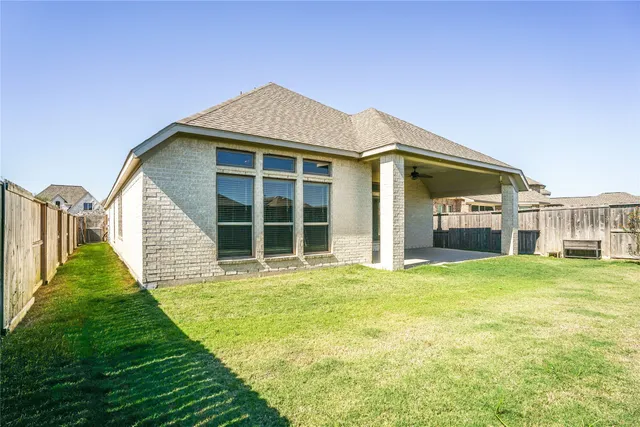 a view of a house with a garden and deck