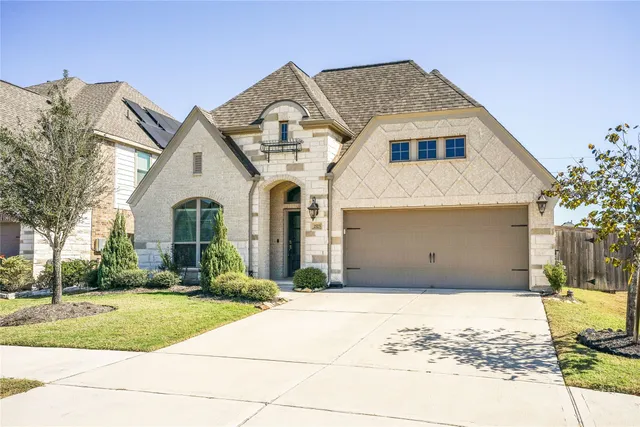 a view of a white house with a yard