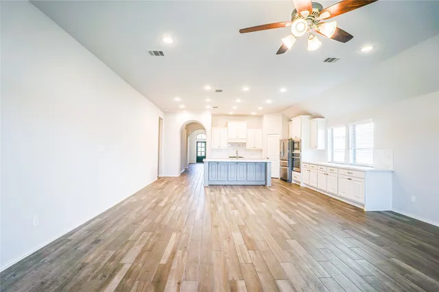 a view of a kitchen with wooden floor and a kitchen counter