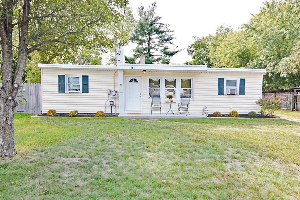 111 Groton Street Springfield, MA 01129 - Photo 1 of 26 a backyard of a house with outdoor seating and trees