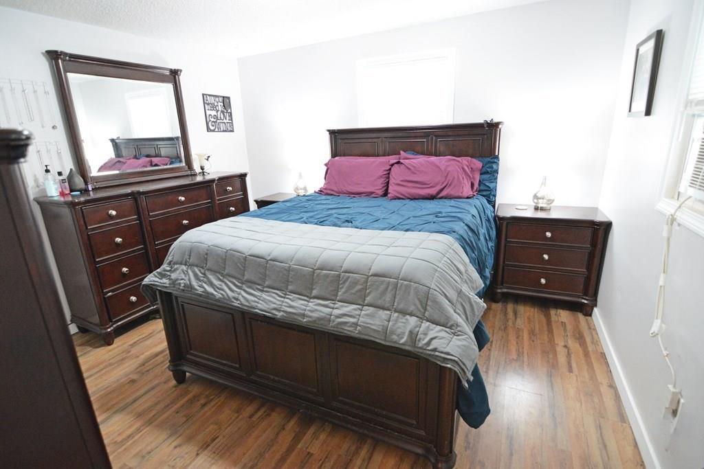 111 Groton Street Springfield, MA 01129 - Photo 13 of 26 a bedroom with a bed and a dresser