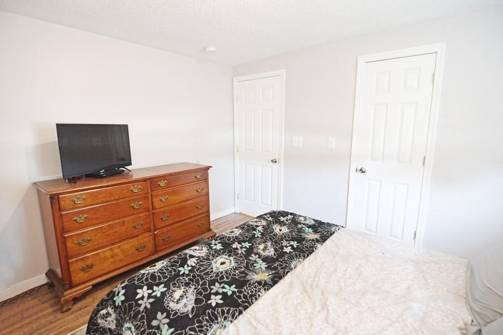 111 Groton Street Springfield, MA 01129 - Photo 16 of 26 a bedroom with a bed and flat screen tv