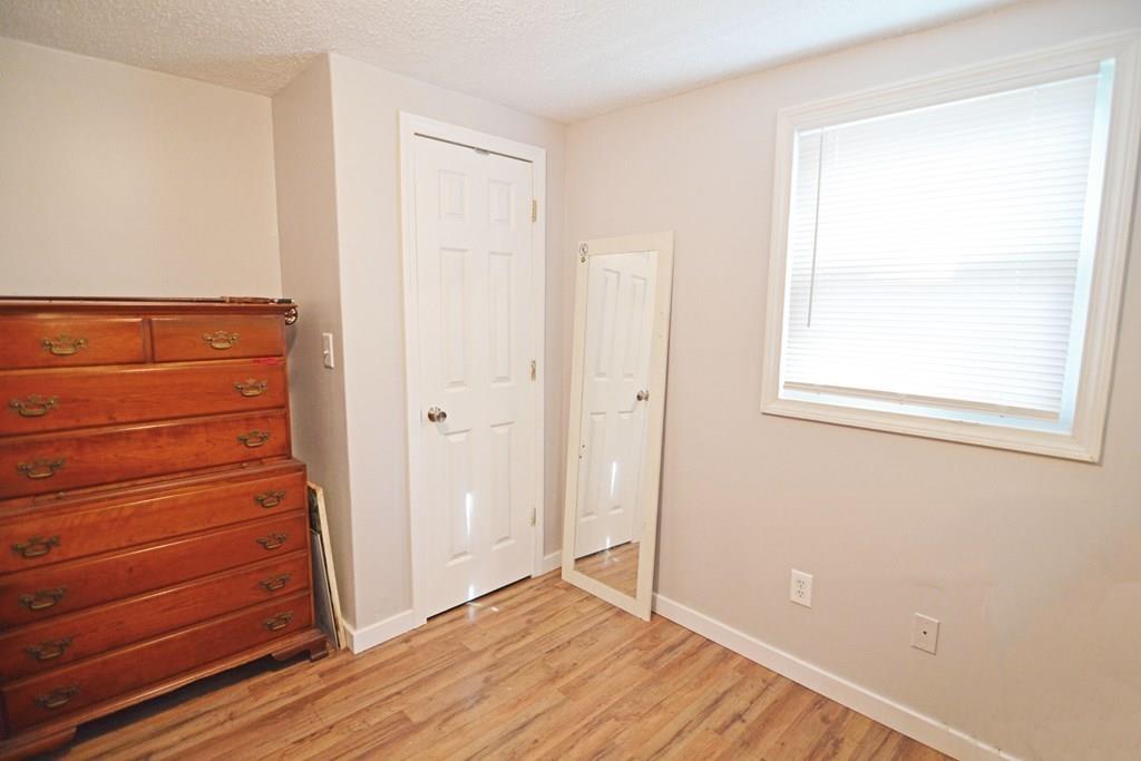 111 Groton Street Springfield, MA 01129 - Photo 18 of 26 a view of an empty room with wooden floor and a window