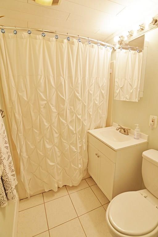 111 Groton Street Springfield, MA 01129 - Photo 19 of 26 a bathroom with a sink a toilet and shower curtain