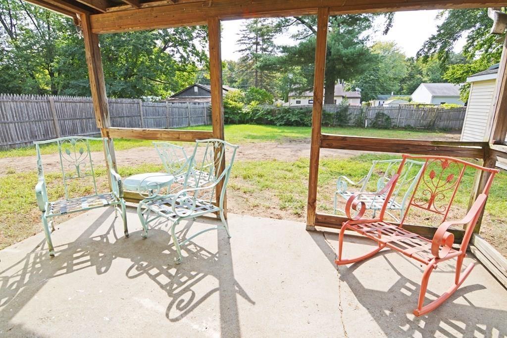 111 Groton Street Springfield, MA 01129 - Photo 21 of 26 a view of a swimming pool with a table and chairs next to a yard