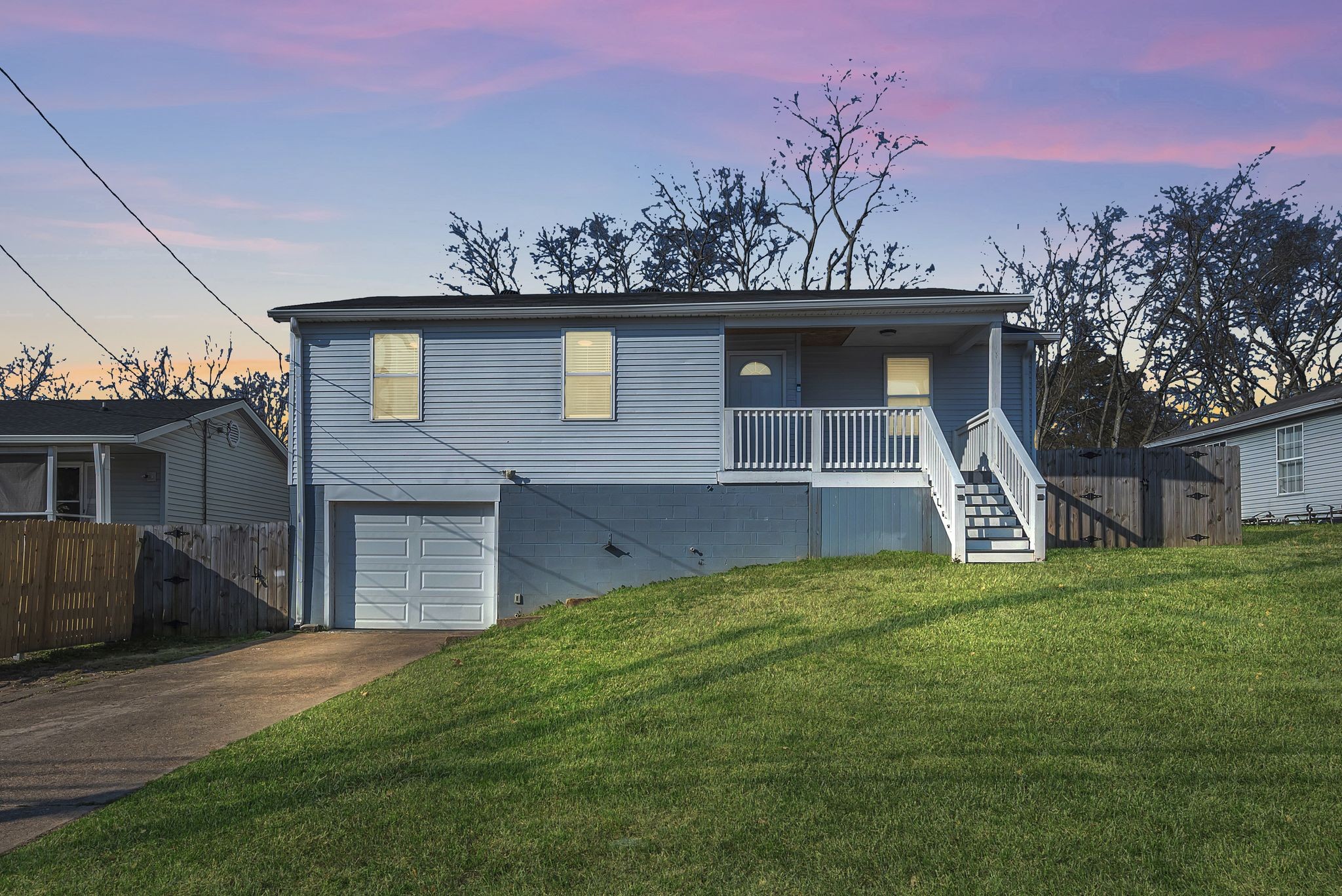 a house that has a tree in front of it