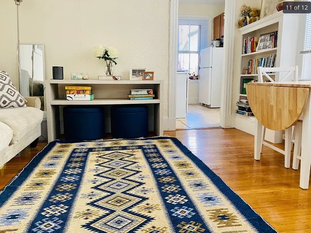 a bedroom with wooden floor rug and a rug