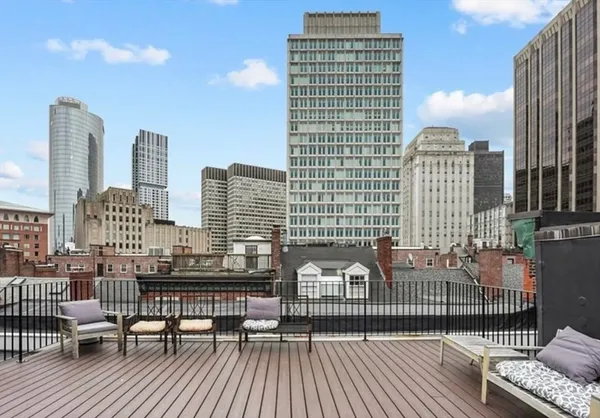 a view of roof deck with two chairs and wooden floor