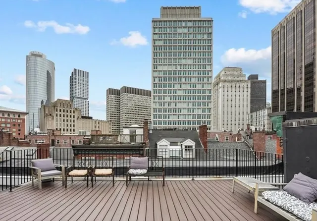 a view of roof deck with two chairs and wooden floor