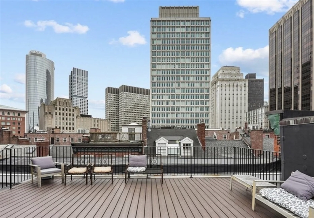 23 Temple Street, Unit 6 Boston, MA 02114 - Photo 3 of 10 a view of roof deck with two chairs and wooden floor