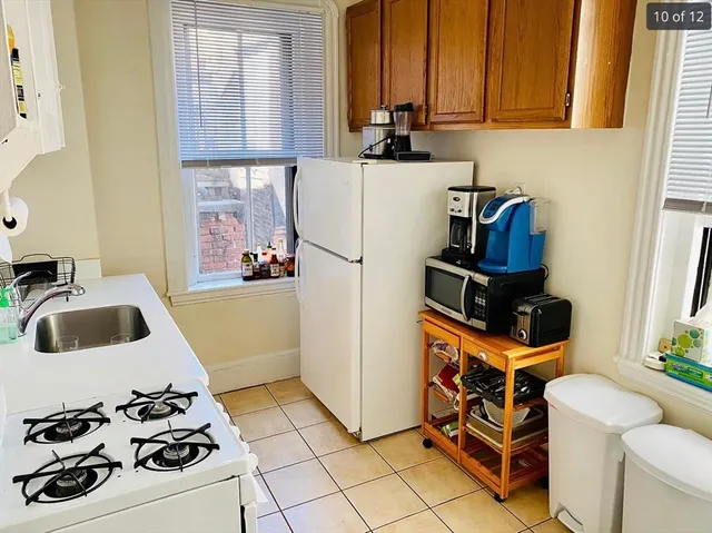 a kitchen with a sink a stove and a refrigerator